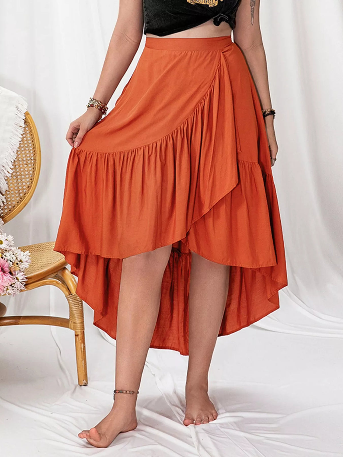 Person wearing an orange skirt with a white background
