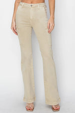 Beige jeans worn by a person on a white background
