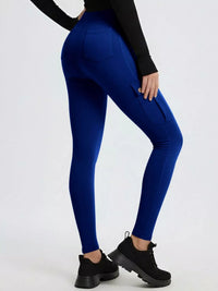 Person wearing blue leggings and black shoes on a white background
