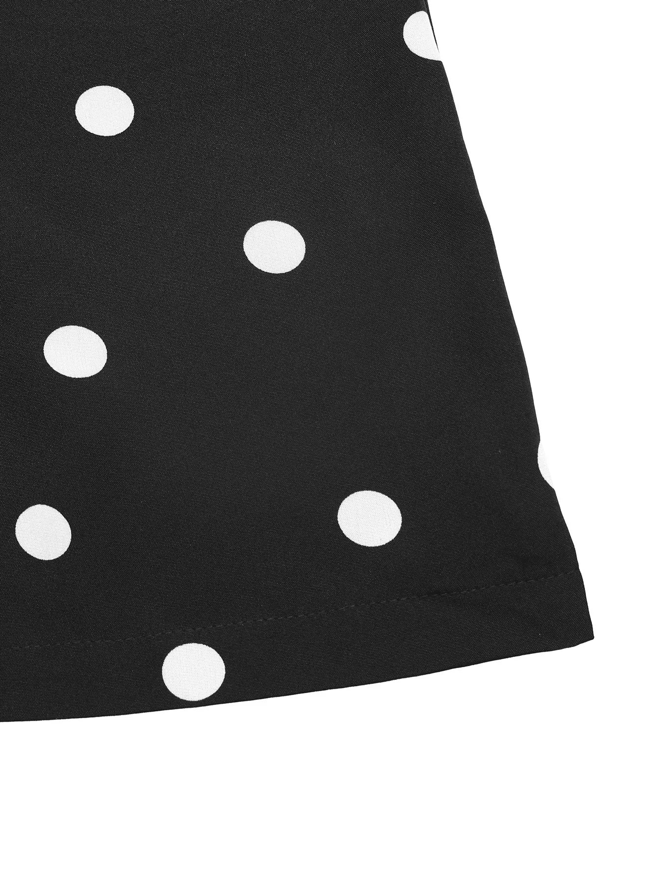 Black fabric with white polka dots on a white background