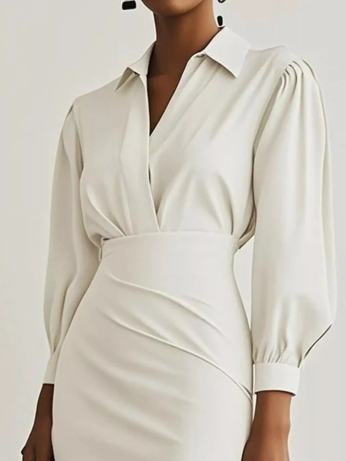 White dress with long sleeves on a plain background