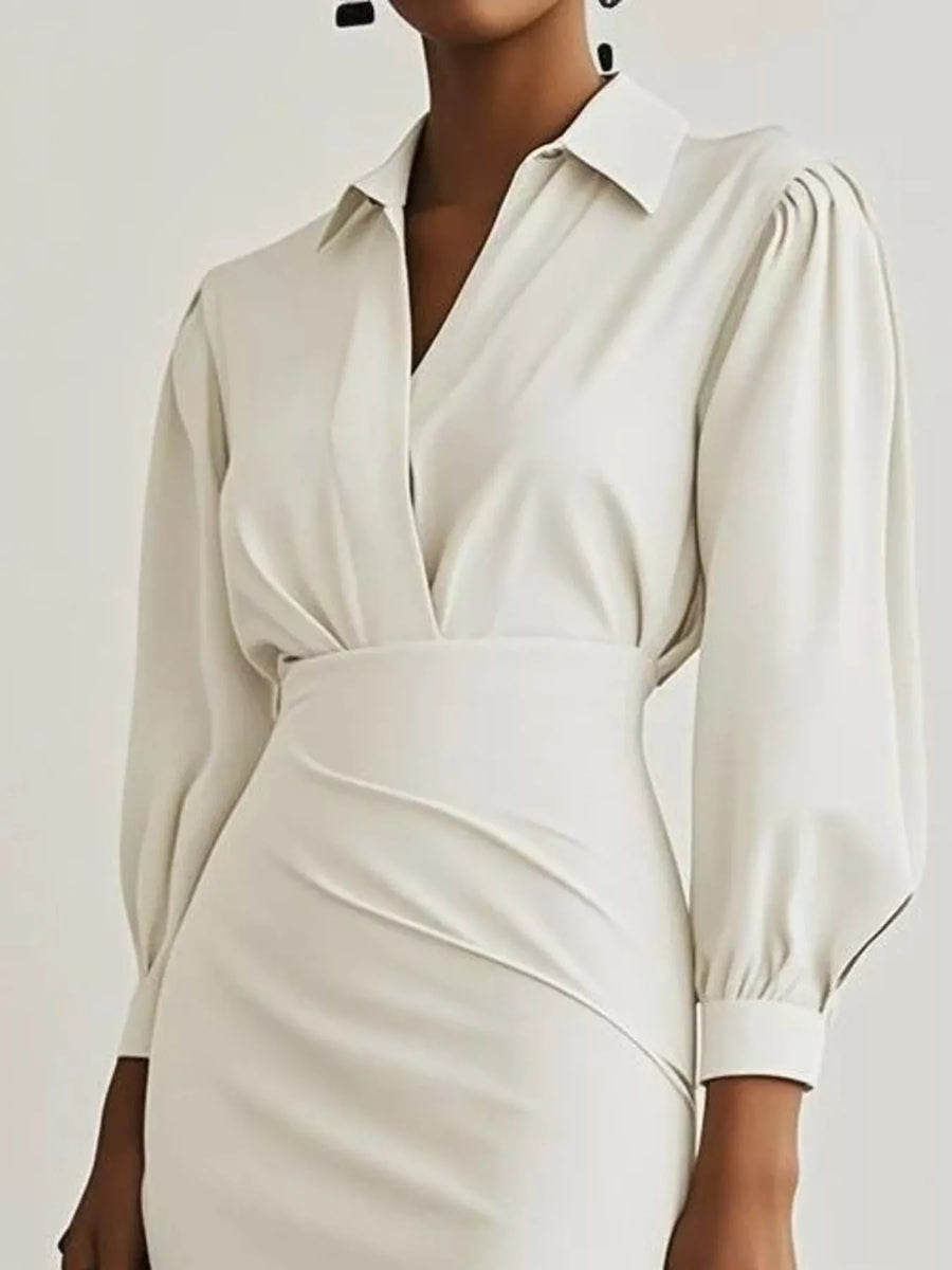 White dress with long sleeves on a plain background