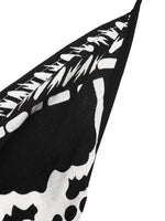 Black and white patterned fabric with abstract shapes on a white background