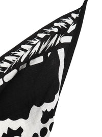Black and white patterned fabric with abstract shapes on a white background