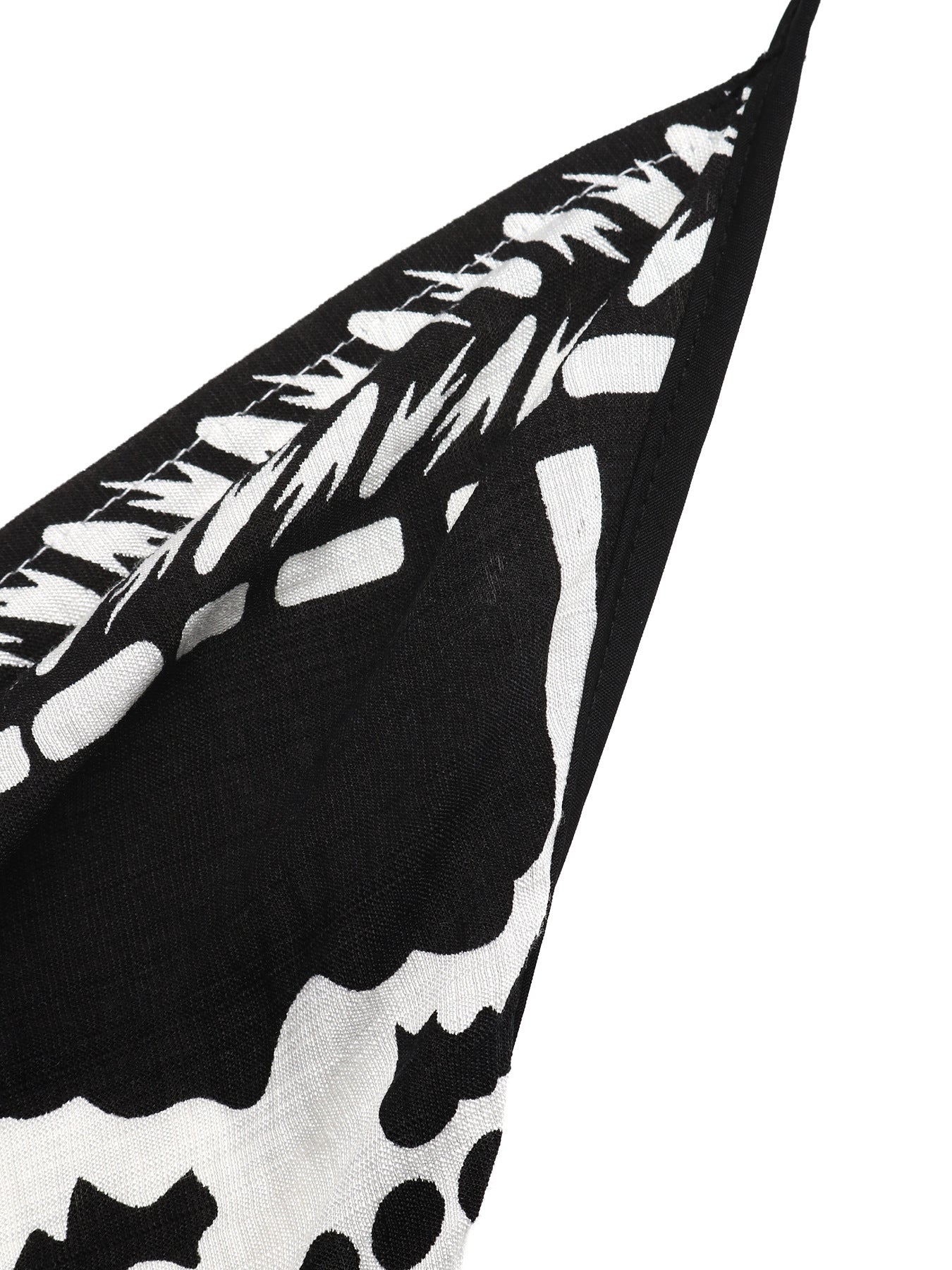 Black and white patterned fabric with abstract shapes on a white background