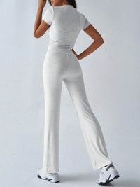 Person wearing a gray jumpsuit on a white background