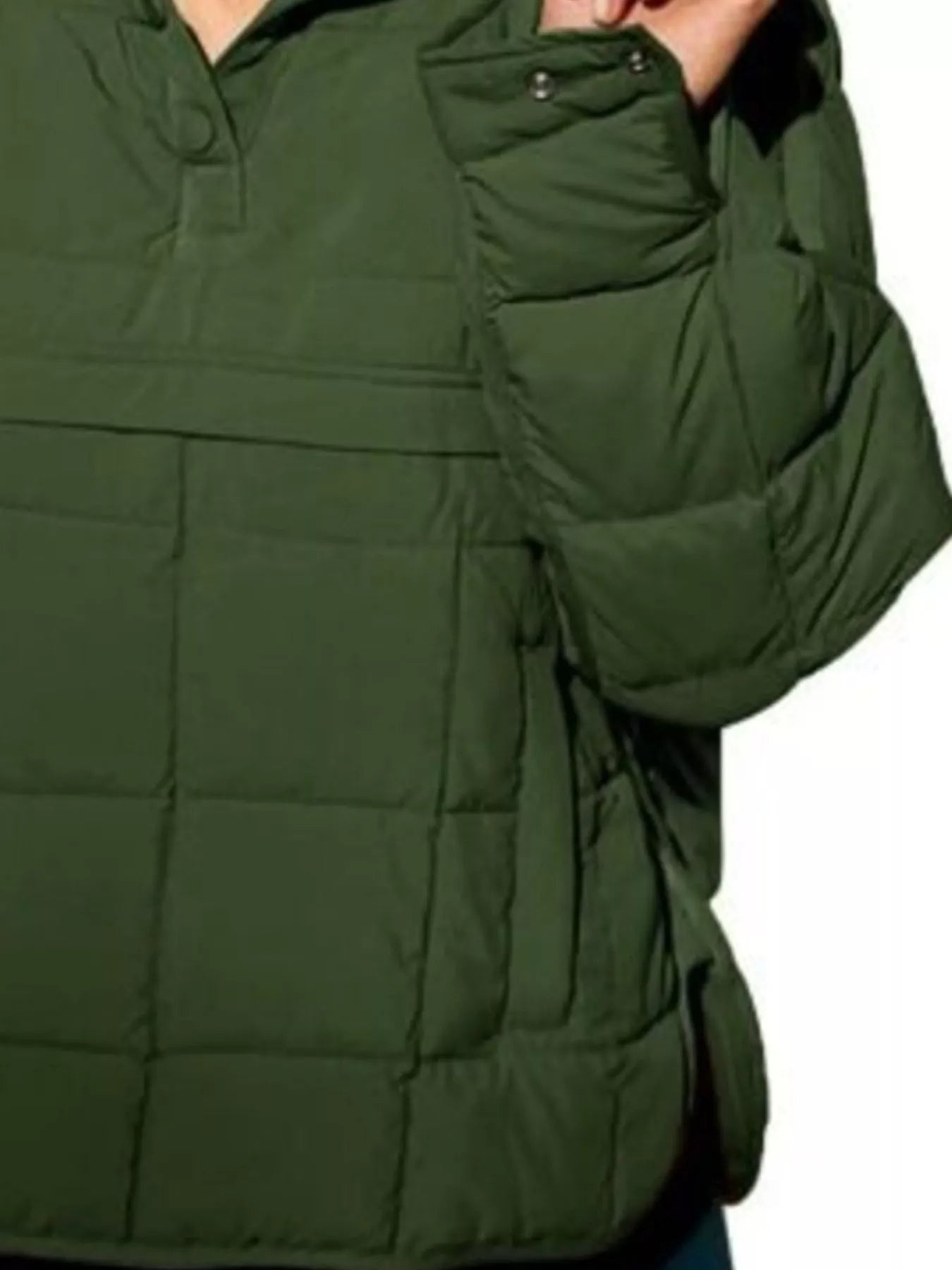 Green puffer jacket worn by a person on a white background