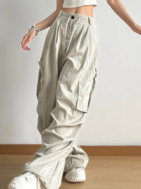 Person wearing beige cargo pants and white shoes on a plain background