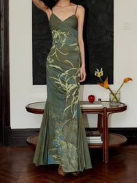 Woman wearing a green floral dress in an indoor setting