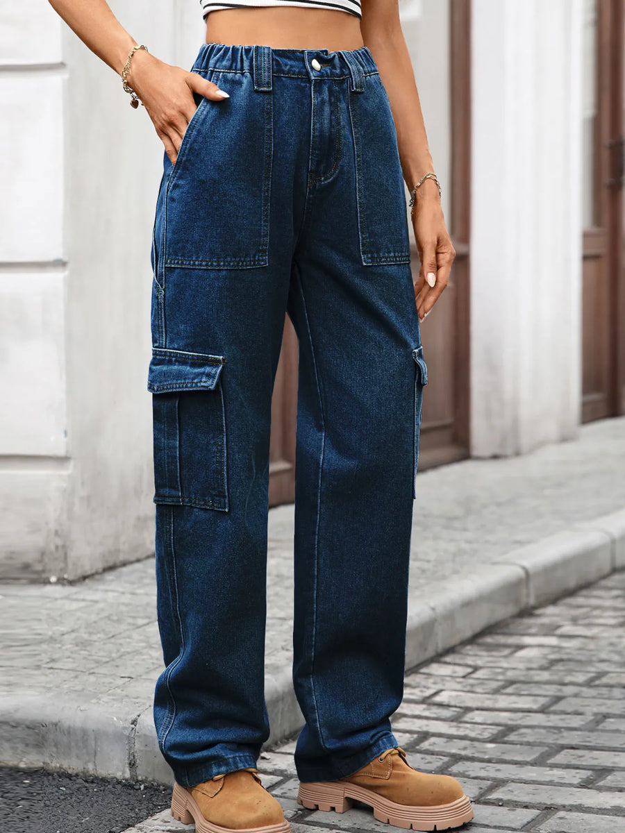 Person wearing blue cargo pants on a street.