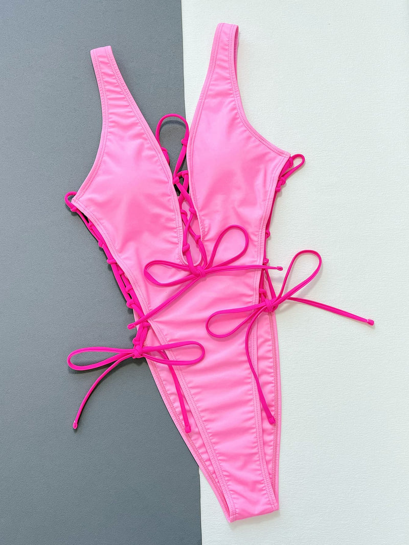 Pink bikini set on a gray and white background