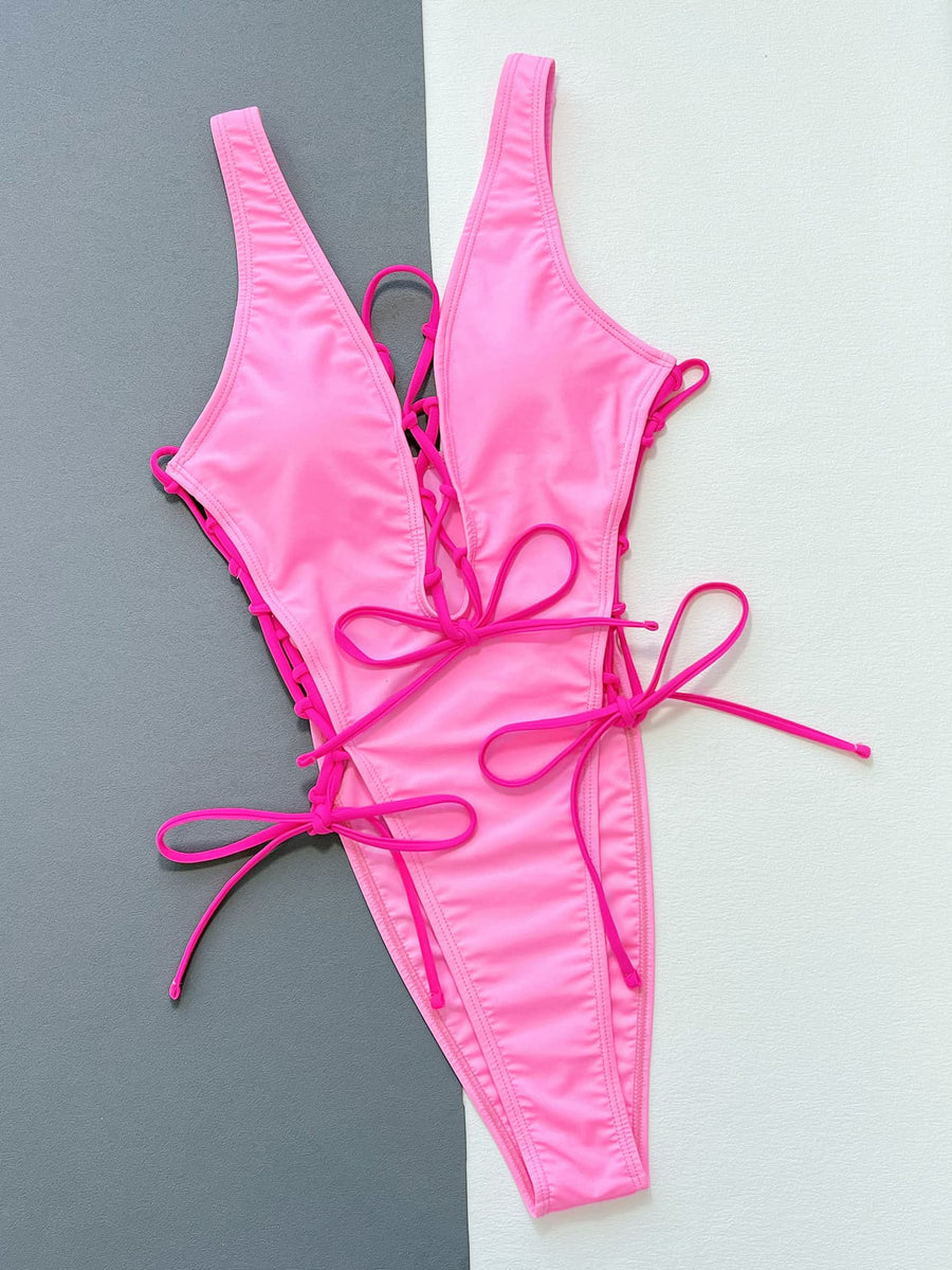 Pink bikini set on a gray and white background