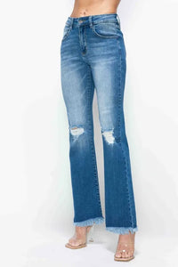 Blue jeans with a slight distressed look on a white background