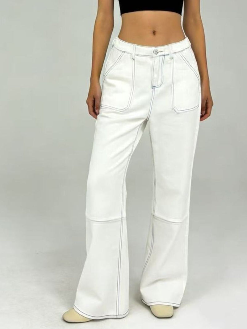 White flared jeans worn by a person on a plain background