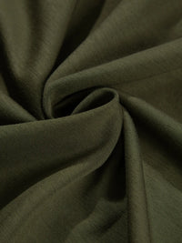 Close-up of dark green fabric with folds