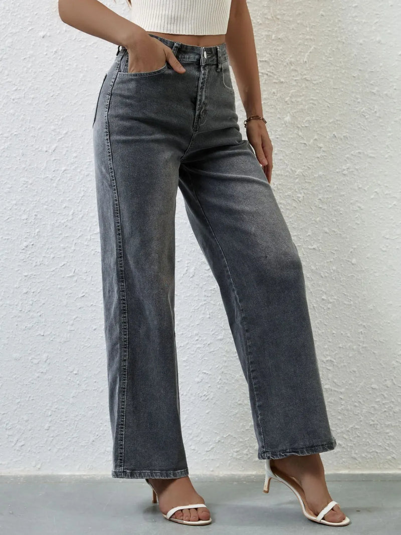 Person wearing gray wide-leg jeans against a light gray background