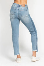 Light blue jeans worn by a person on a white background