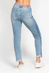 Light blue jeans worn by a person on a white background