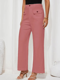 Pink pants worn by a person on a white background