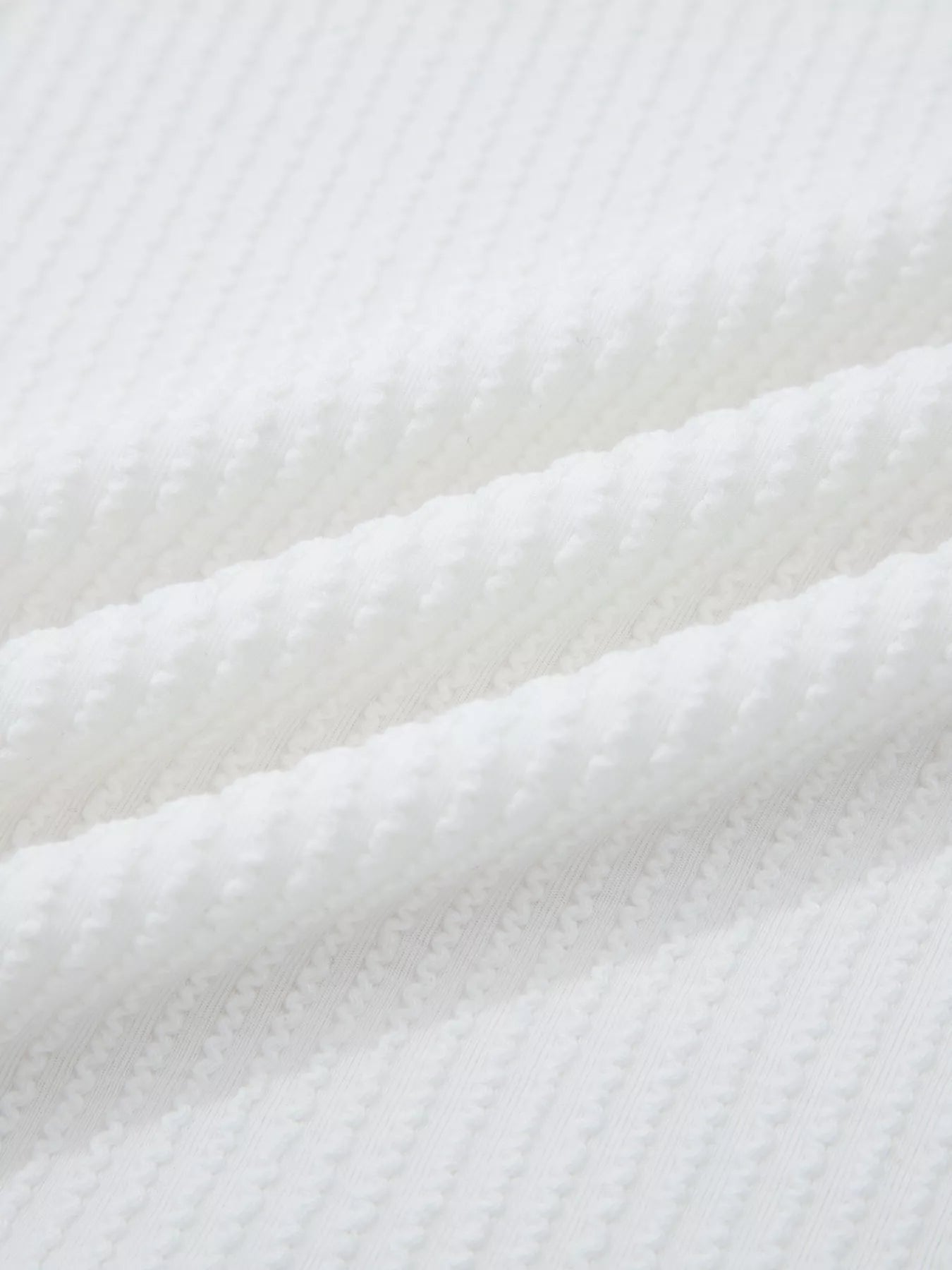 Close-up of white textured fabric