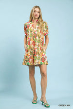 Woman wearing a colorful floral dress on a light blue background