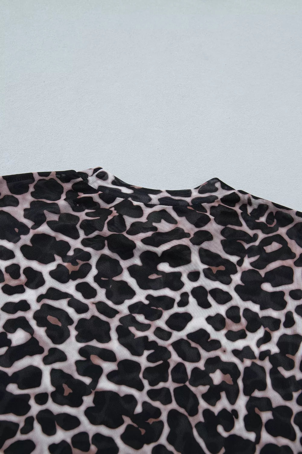 Leopard print fabric on a light gray background