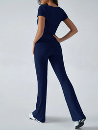 Navy blue jumpsuit worn by a person on a white background