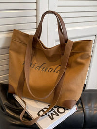 Brown tote bag with visible branding on a magazine