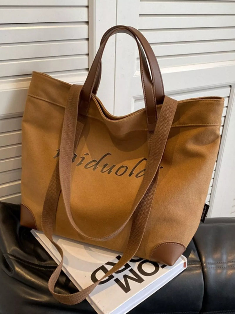 Brown tote bag with visible branding on a magazine