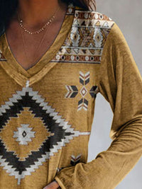 Mustard yellow sweater with geometric pattern on a plain background