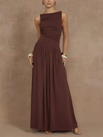 Woman wearing a brown one-shoulder dress against a beige background