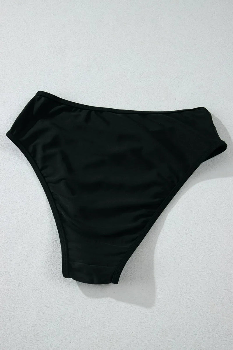 Black bikini bottom on a light gray background