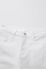 Close-up of white jeans with a visible brand logo on a white background