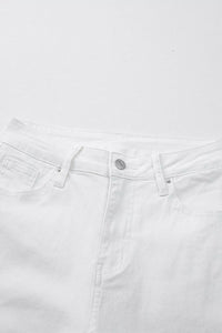 Close-up of white jeans with a visible brand logo on a white background