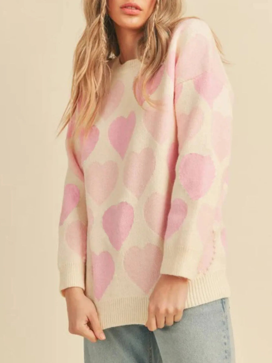 Woman wearing a sweater with pink hearts on a beige background