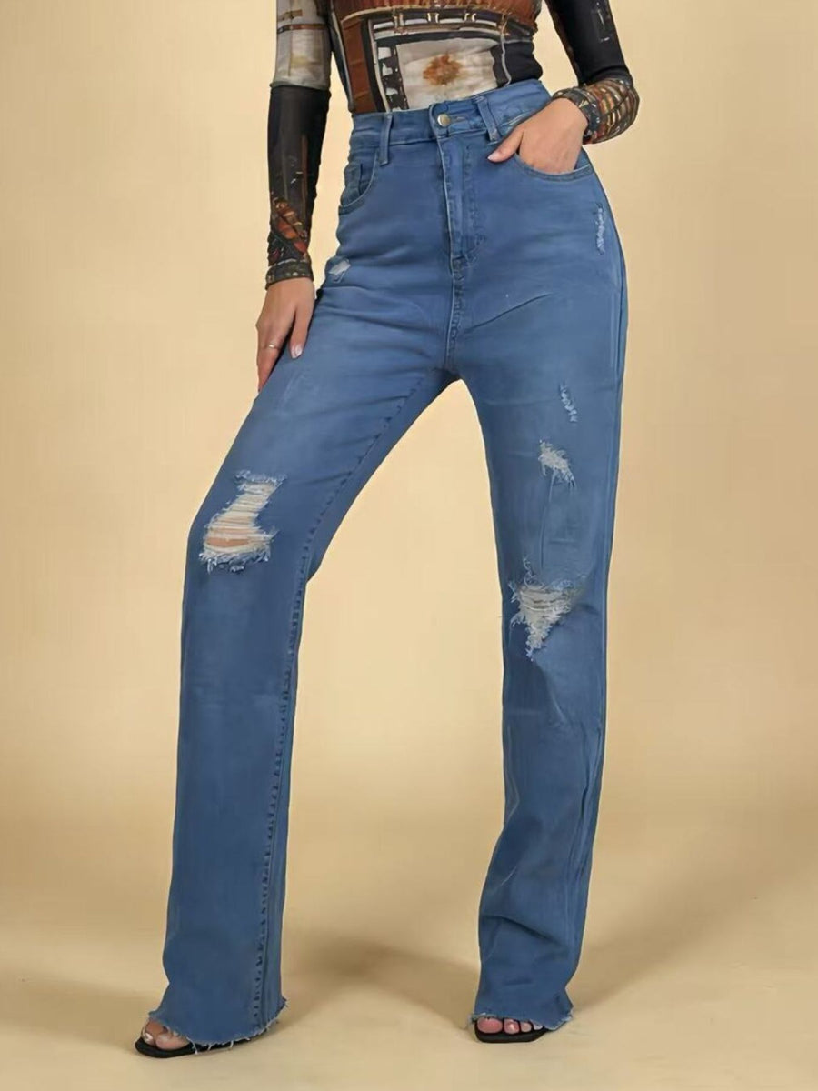Person wearing blue jeans on a beige background