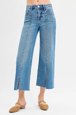Blue jeans worn by a person on a white background