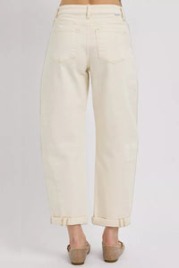Beige jeans worn by a person on a white background