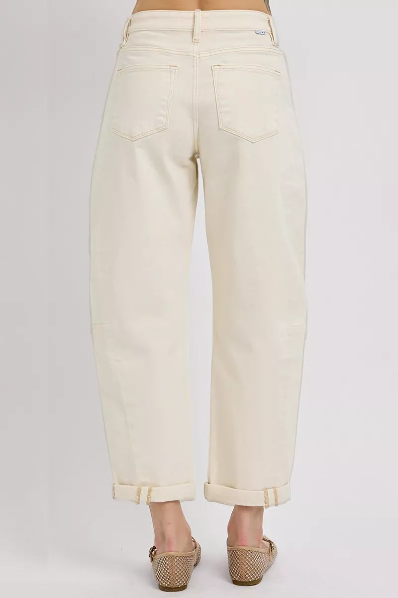 Beige jeans worn by a person on a white background