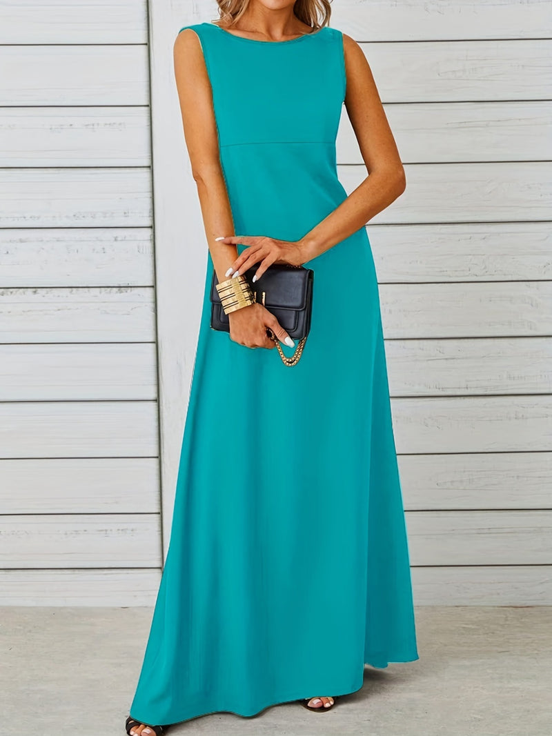 Woman wearing a teal sleeveless dress holding a black clutch against a light wooden background