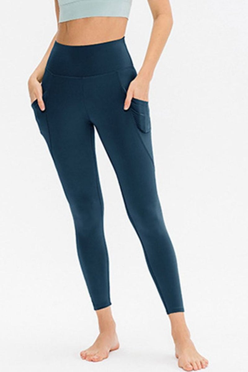 Navy leggings worn by a person on a white background