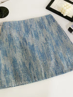 Blue textured placemat on a white surface with decorative items.