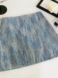 Blue textured placemat on a white surface with decorative items.