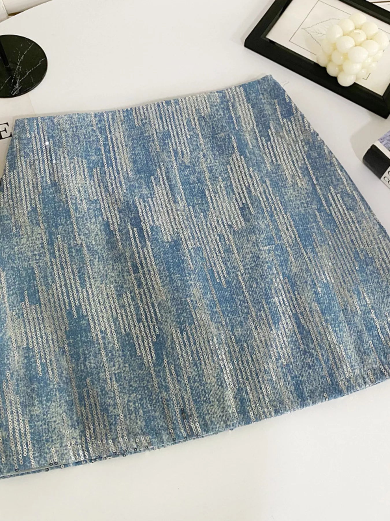 Blue textured placemat on a white surface with decorative items.