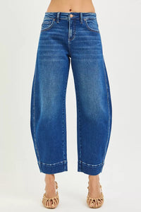 Blue jeans worn by a person on a white background