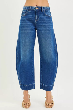 Blue jeans worn by a person on a white background