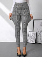 Plaid pants worn by a person with abstract art in the background