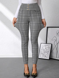 Plaid pants worn by a person with abstract art in the background