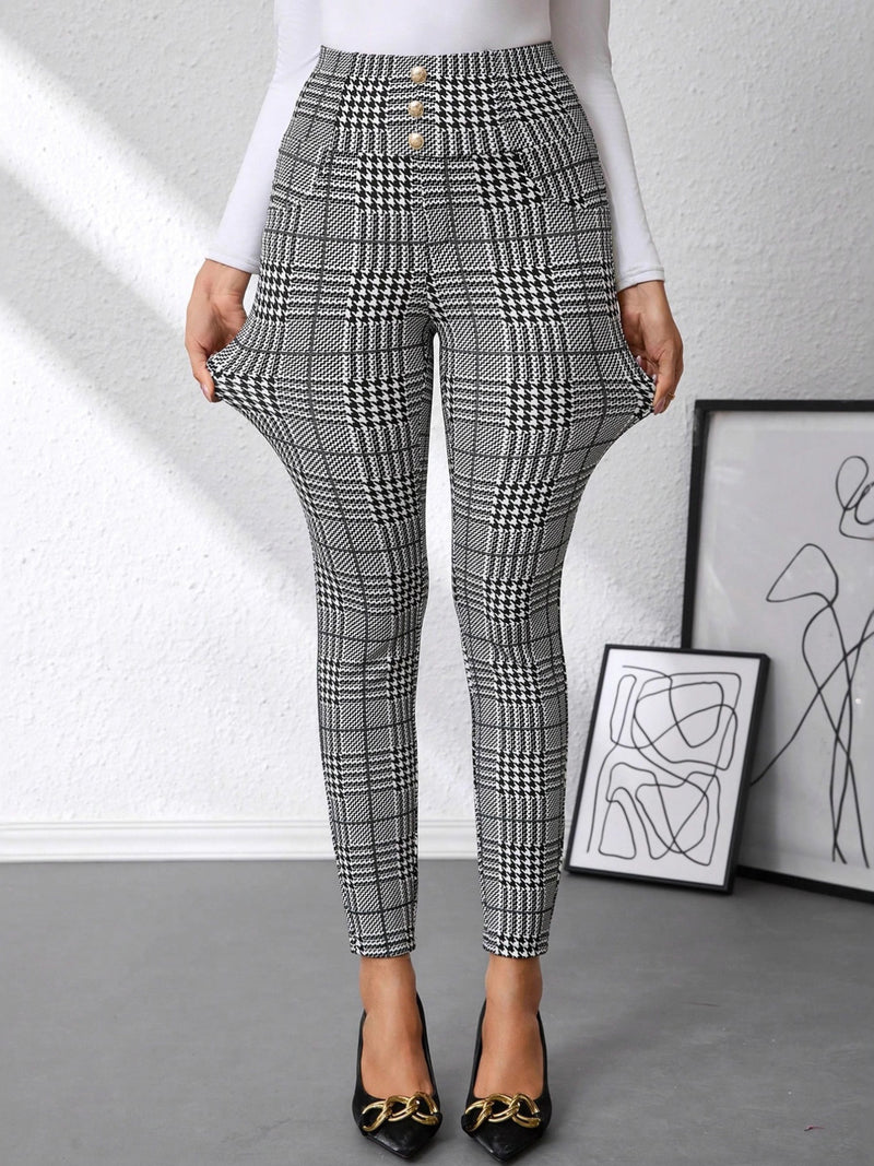 Plaid pants worn by a person with abstract art in the background