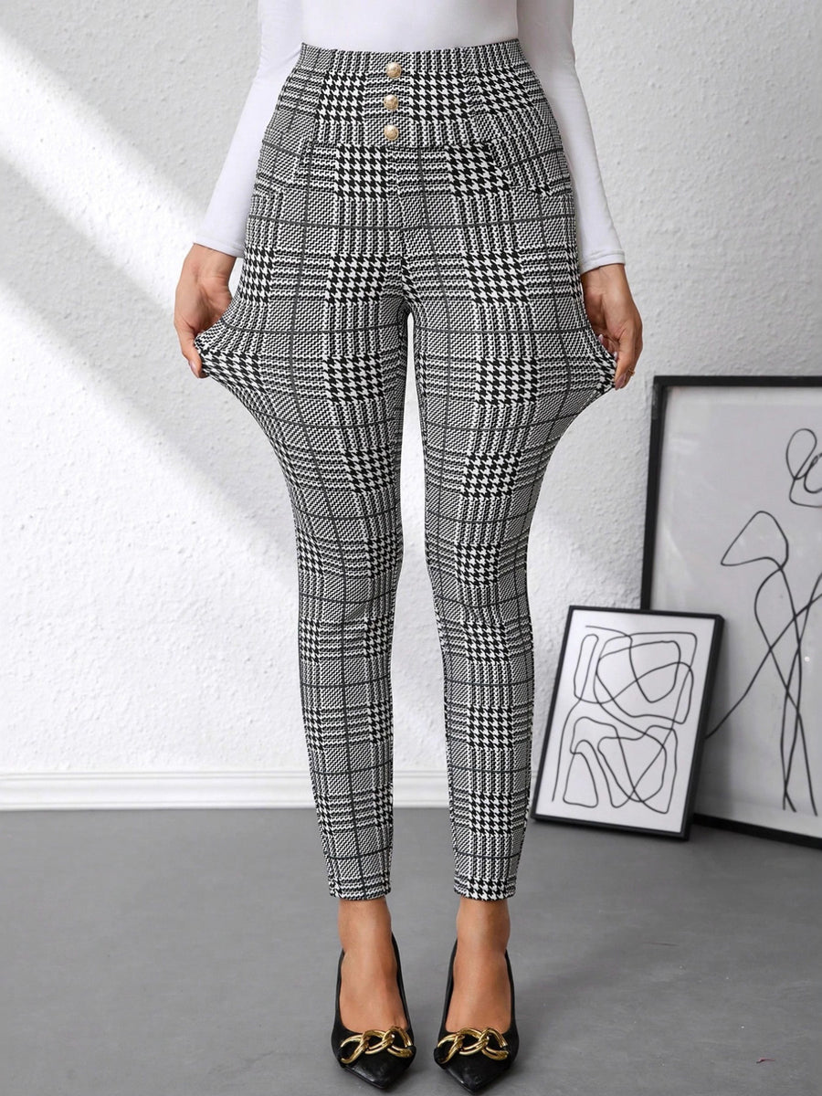 Plaid pants worn by a person with abstract art in the background
